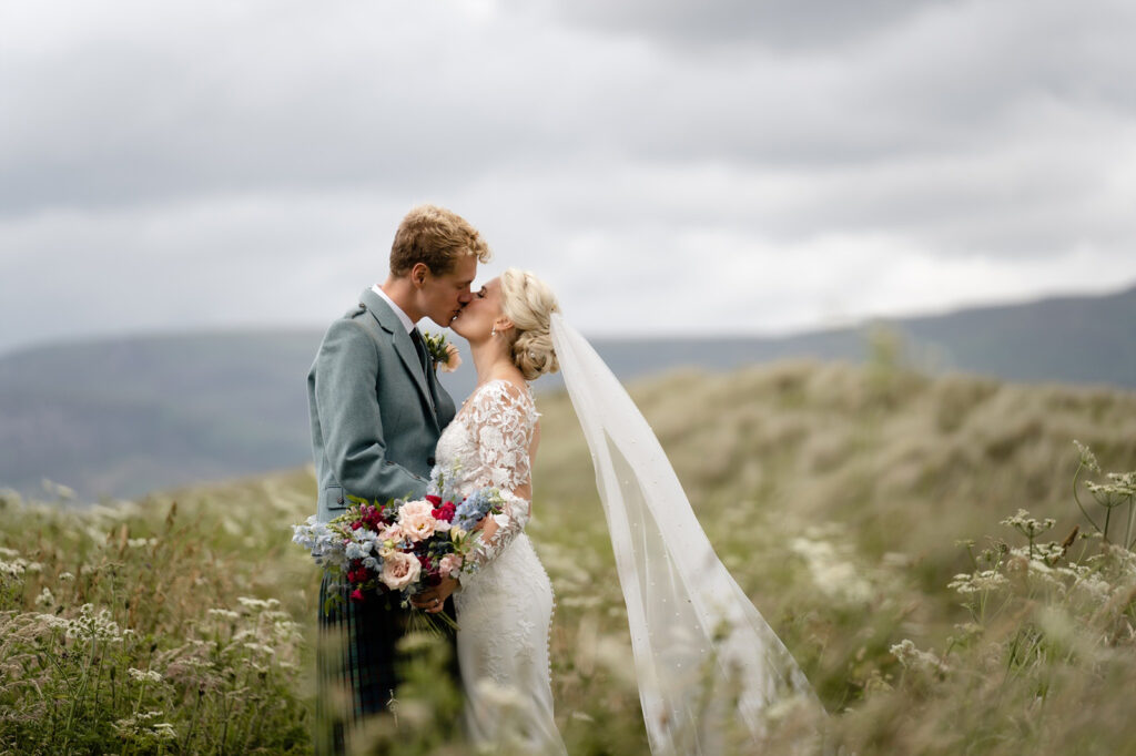 Photograph of married couple on wedding day in landscape